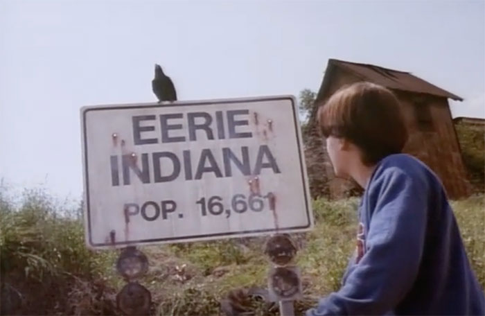 Marshall looking at town sign in Eerie, Indiana