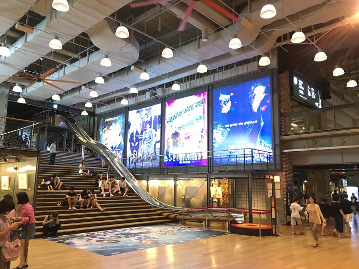 Massive movie theater with a long slide near the stairs 
