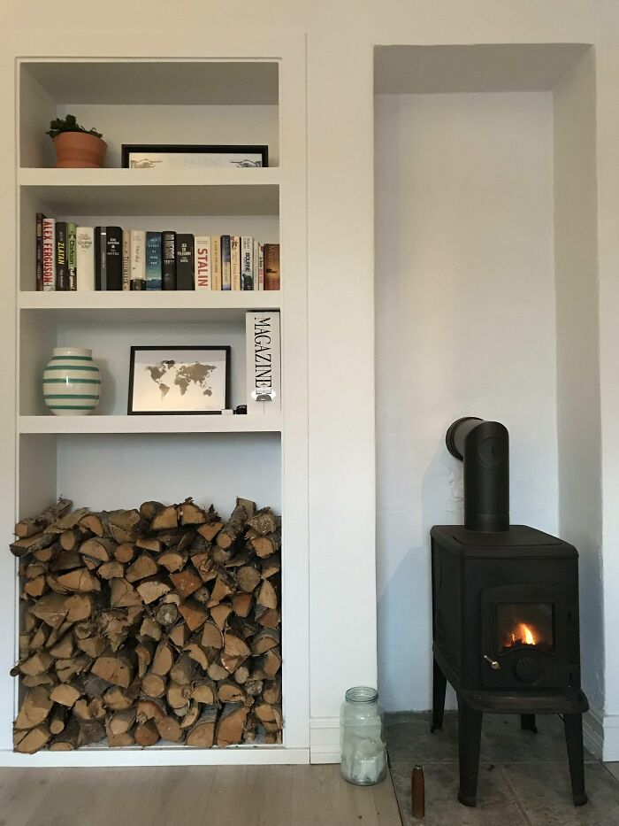 Bookshelf wall next to a fireplace 