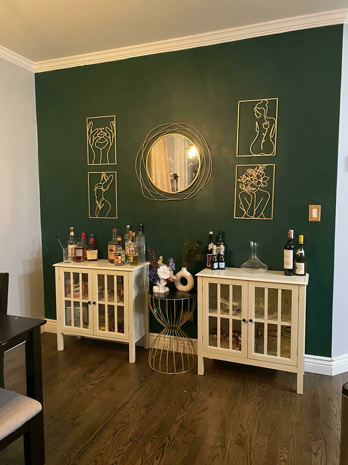 Metal paintings on the green wall 