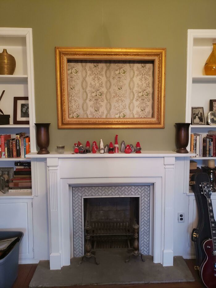 Wallpaper in the frame above the fireplace