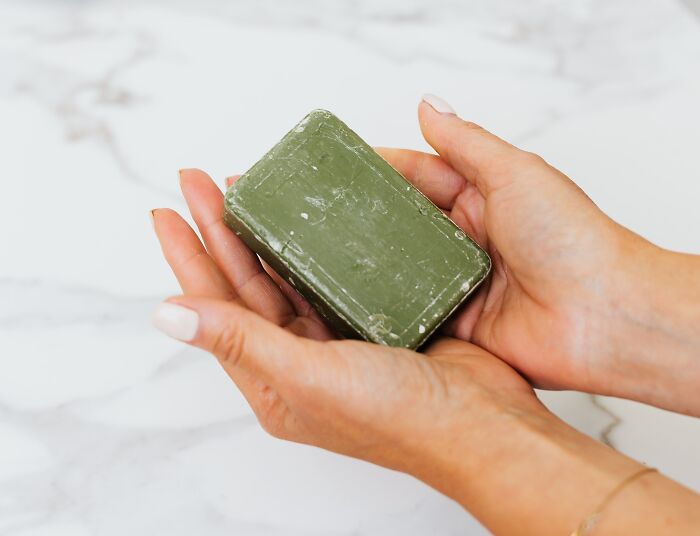 Woman holding a green soap 