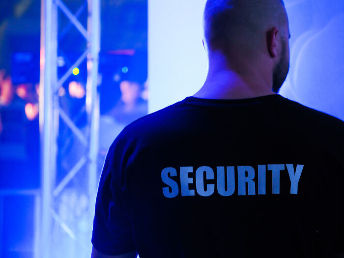 A man wearing T-shirt that says "Security"