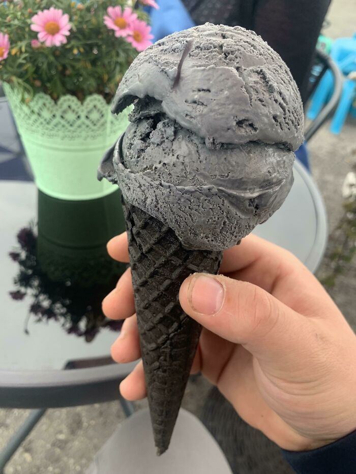Grey ice cream in brown cone 