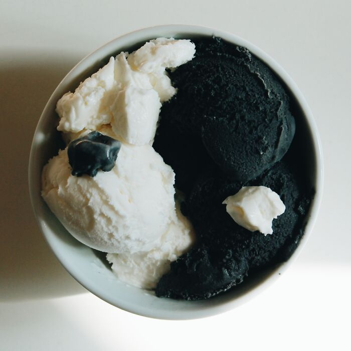 A bowl with black and white ice cream 