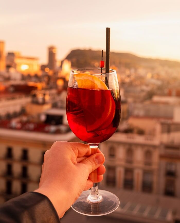 person holding a glass of Sangria in his hand