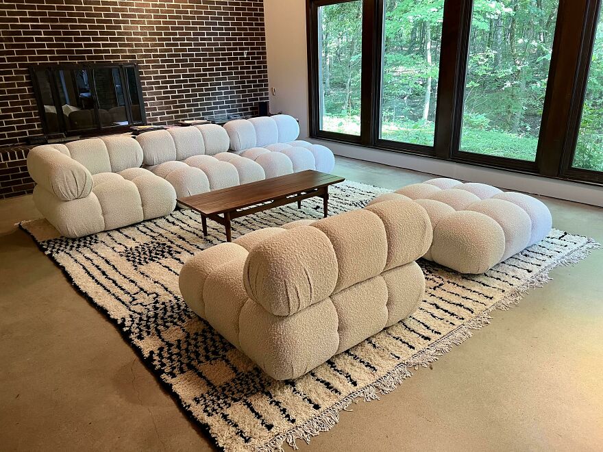 White couch next to a wooden coffee table 