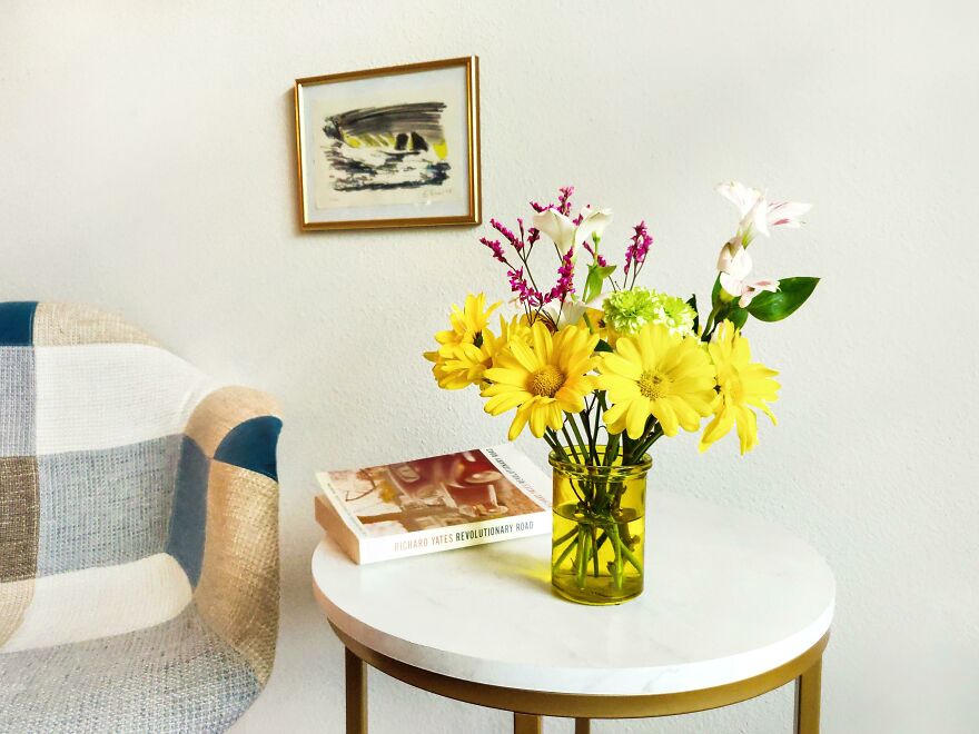 Coffee table with yellow flowers in the vase 
