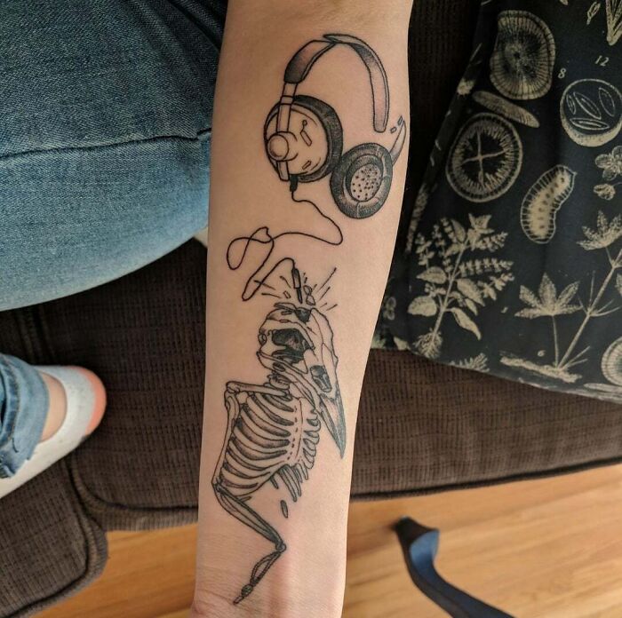 Tattoo with skeleton and headphones