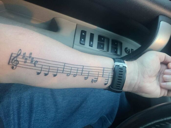 Musical notes arm tattoo