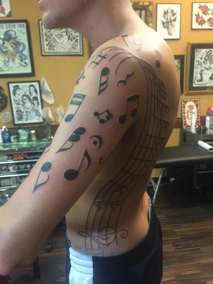 Large black music notes tattoo