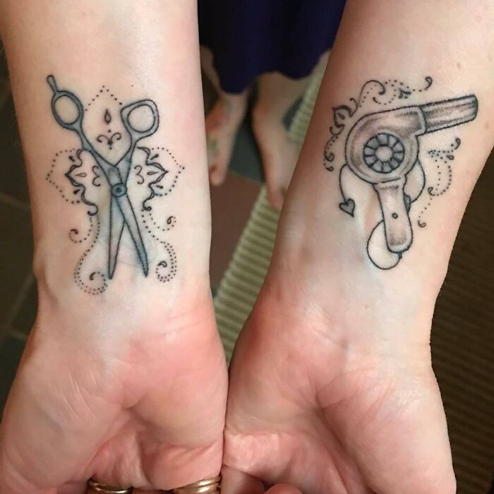 Scissors and hair dryer tattoos on wrist