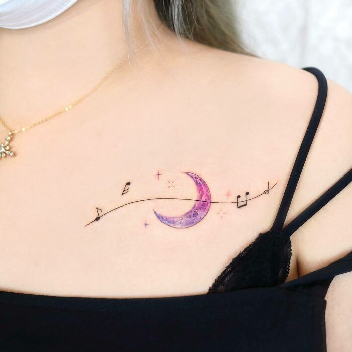 Purple moon and black music notes tattoo