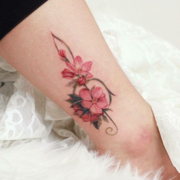 Realistic red flowers and musical note tattoo