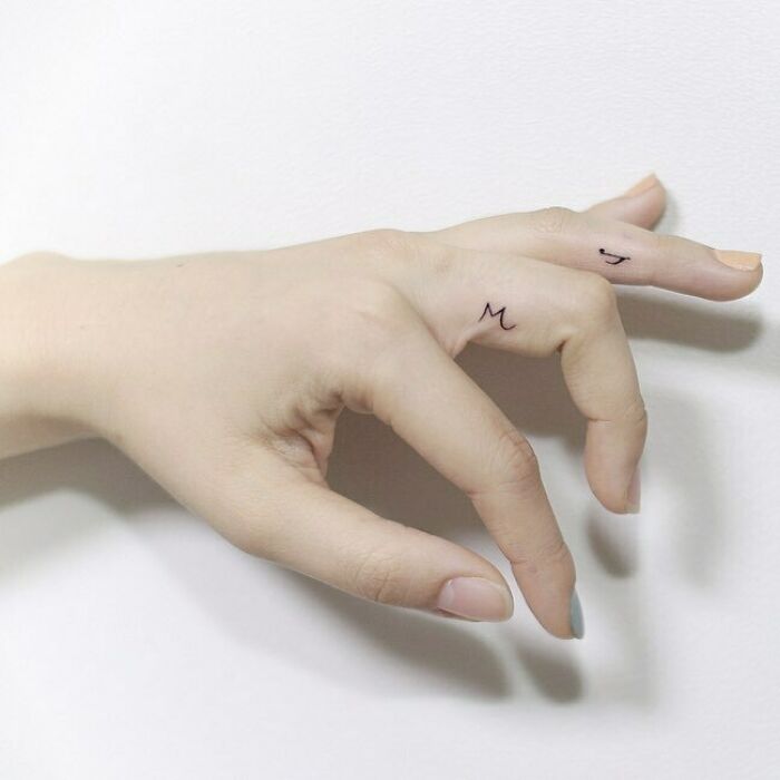 Small music note tattoo on finger