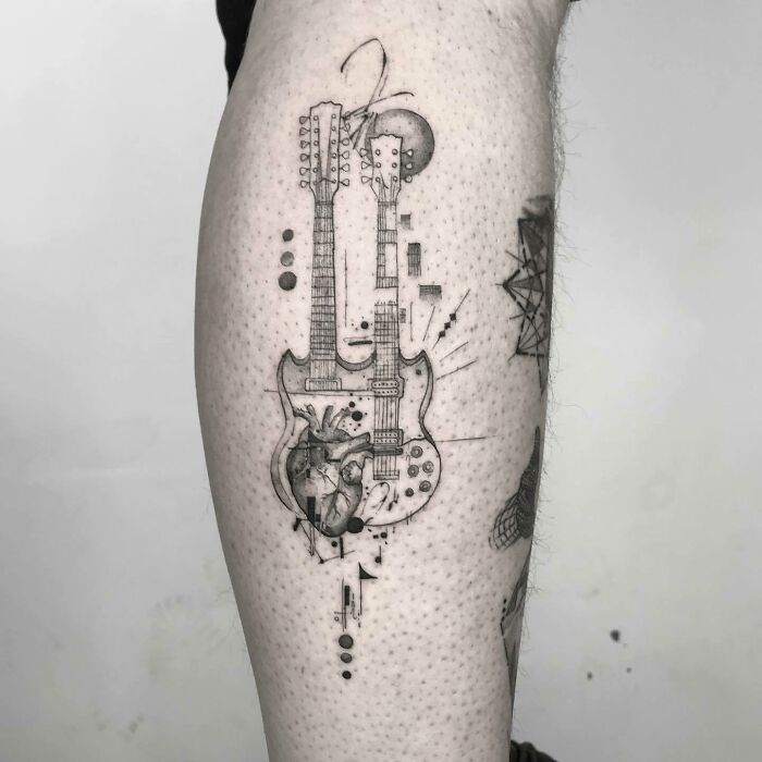 Double-neck guitar with heart calf tattoo