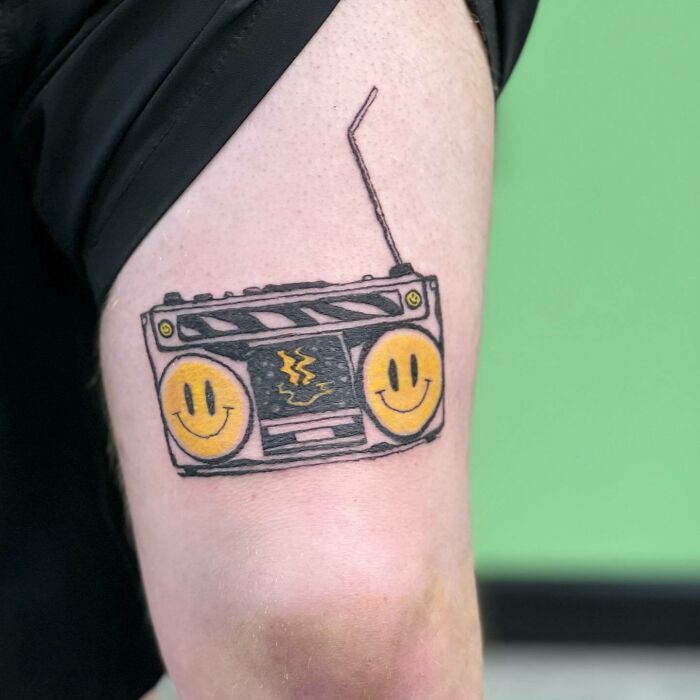 Rave Radio with yellow smileys tattoo