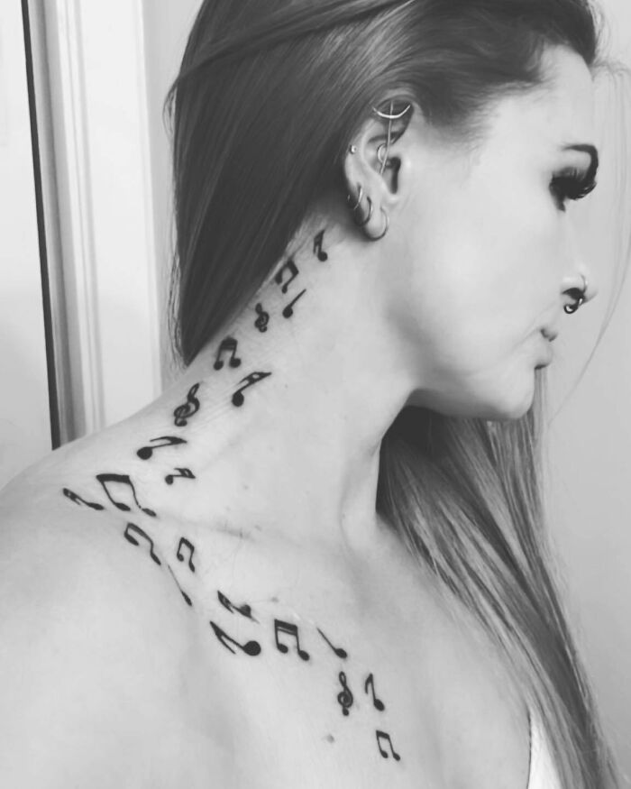 Music notes tattoo on neck and chest