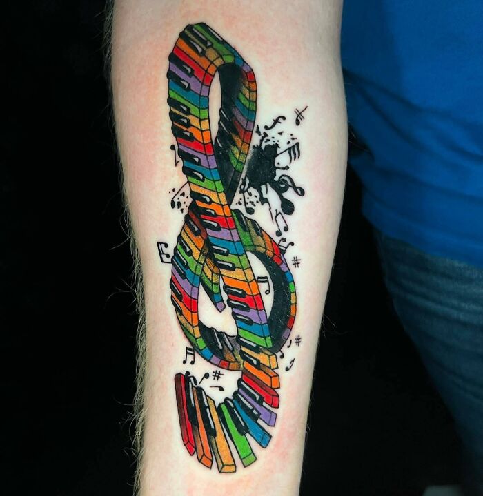 Colorful music note tattoo consisting of piano keys