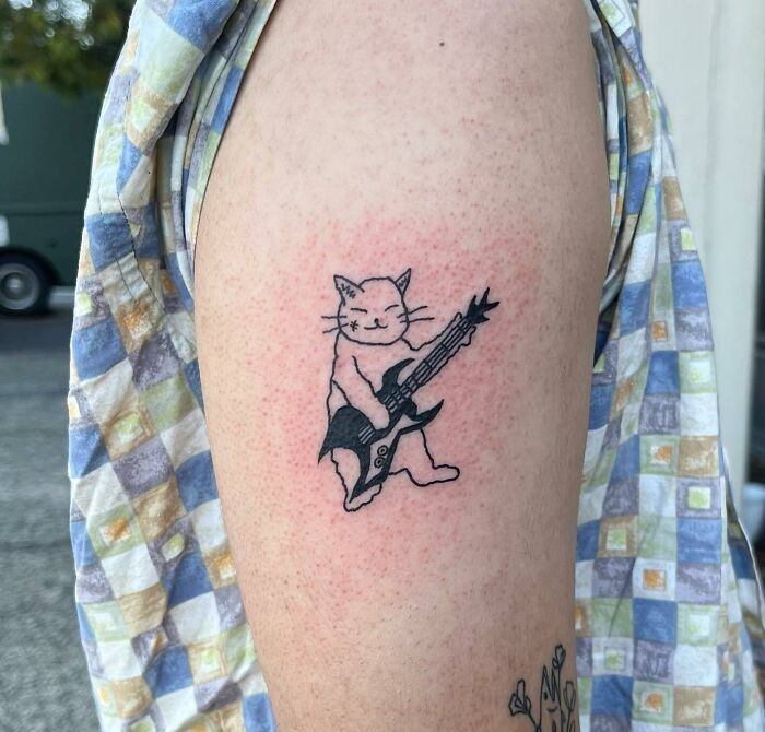 Cat playing guitar tattoo