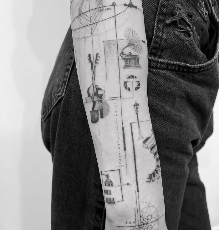 Geometric and realistic tattoo with music instruments