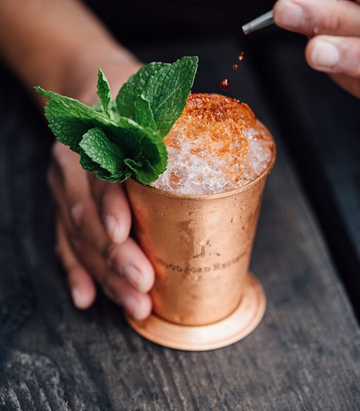 Brass-colored cup filled with crushed ice with mint