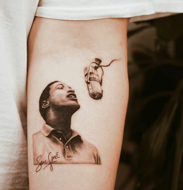 Realistic arm tattoo of Sam Cooke singing