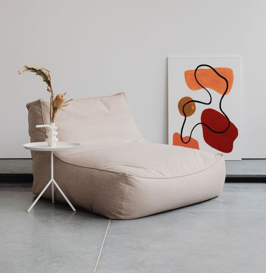 White chair next to an abstract painting 