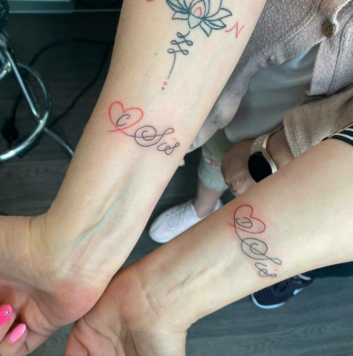 Family matching words arm tattoos