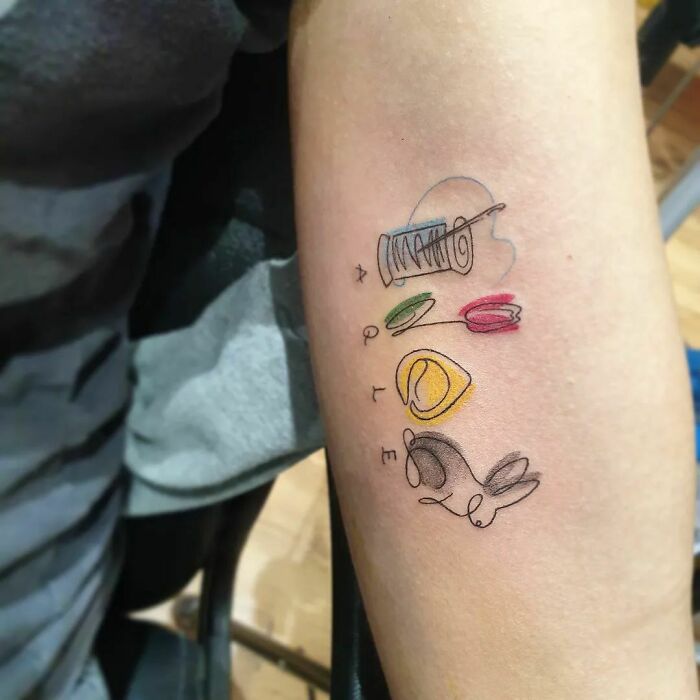 Colorful family letter arm tattoo
