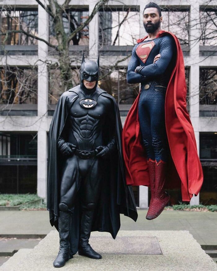 Persons cosplaying Batman and Superman