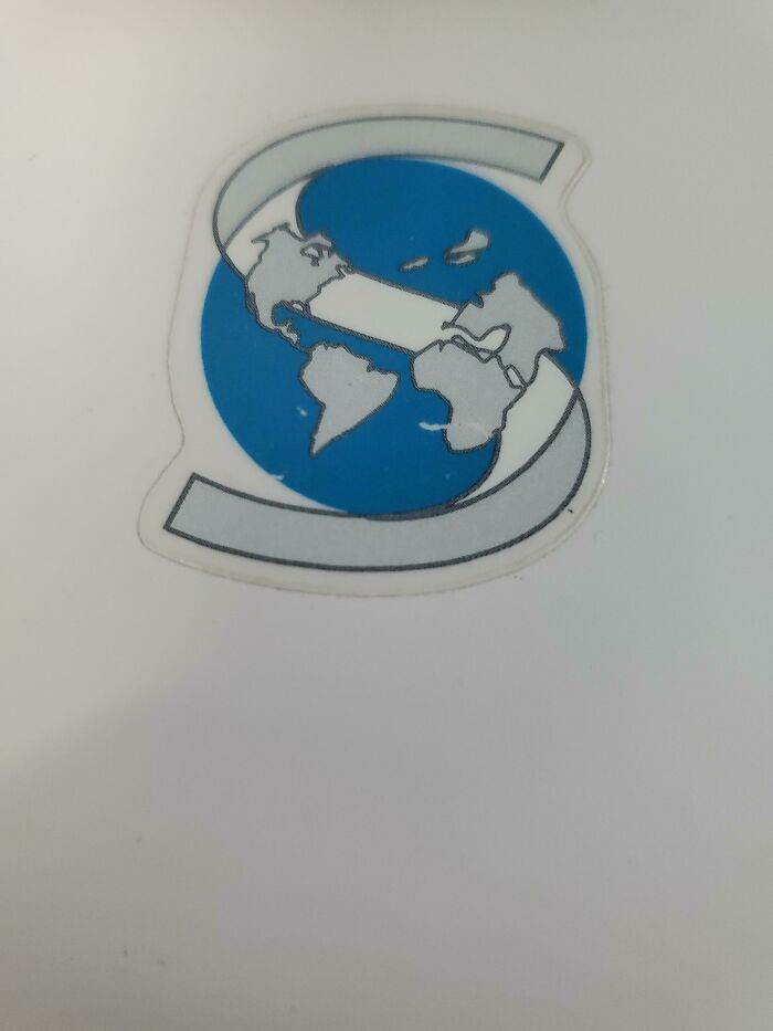 A Logo Including A Globe Where Greenland, Iceland And The UK Have Decided To Fly Away Into The Arctic