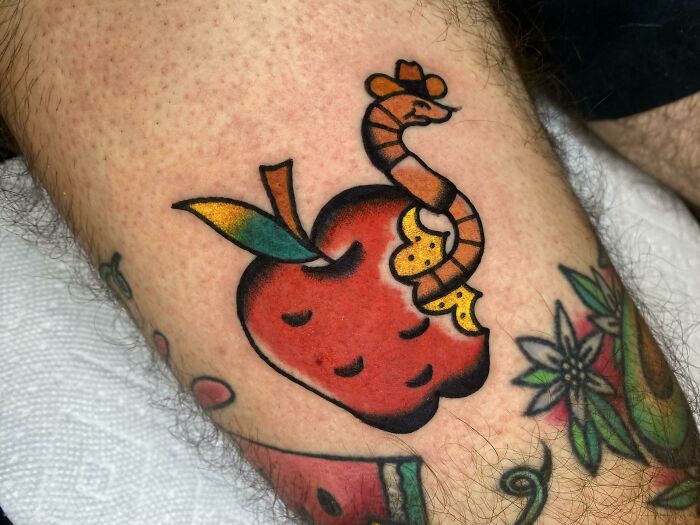 Bitten red apple with a worm inside watercolor tattoo