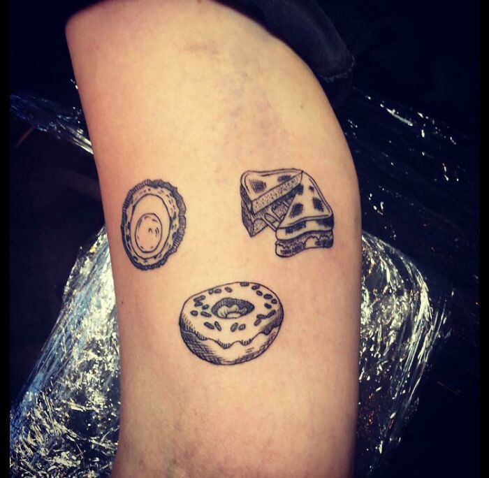 Food tattoo ideas featuring toasted cheese sandwich, fried egg, and donut designs on skin.