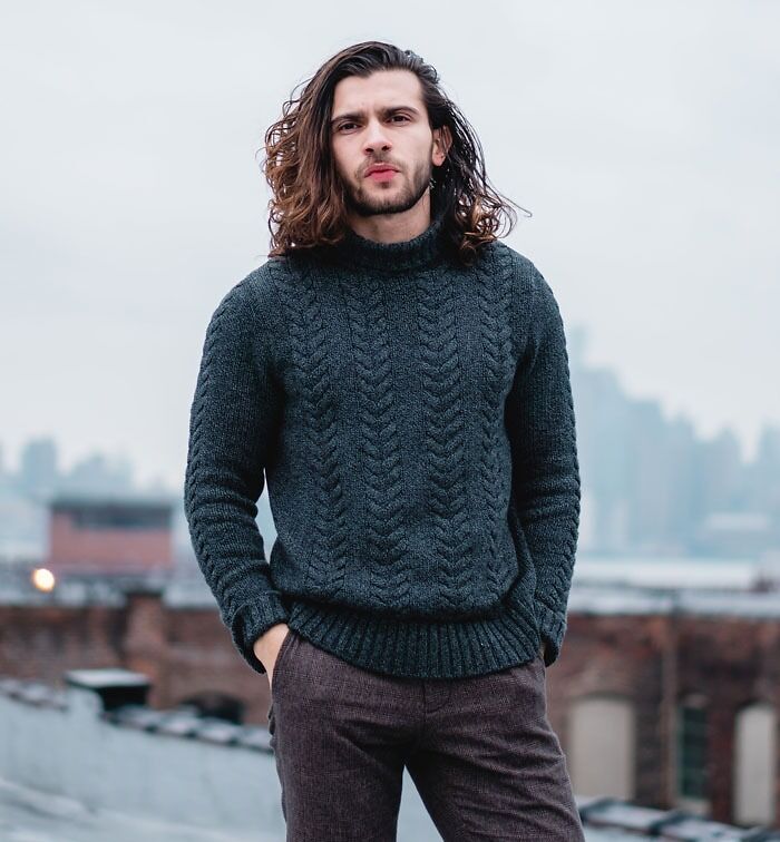 Man standing and wearing black sweater