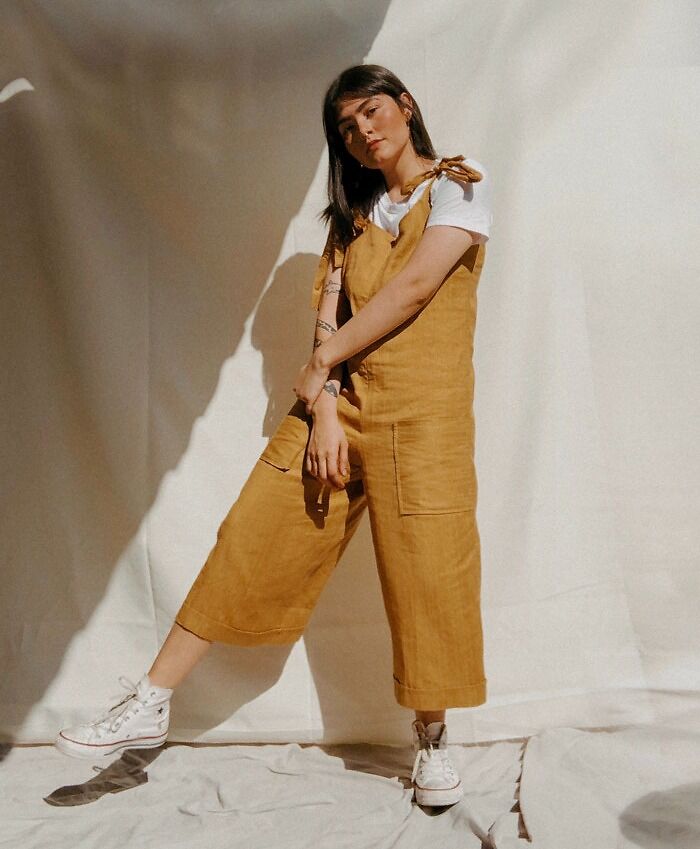 Woman standing and wearing yellow dress