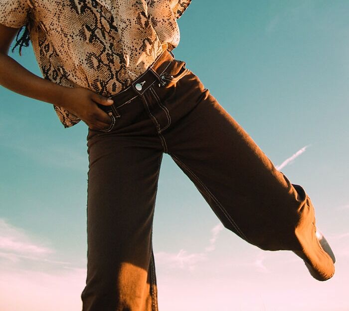 Woman wearing brown jeans and brown shirt