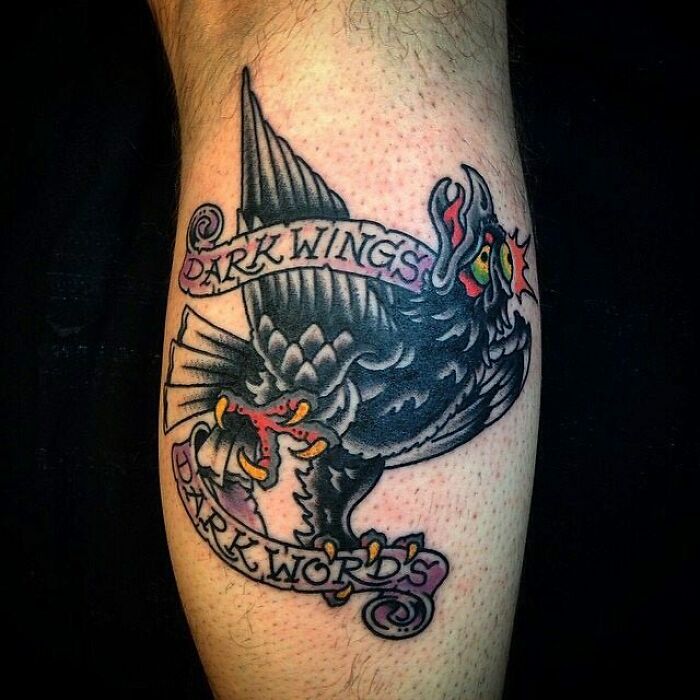 American traditional tattoo of a black crow with banners reading "Dark Wings Dark Words."
