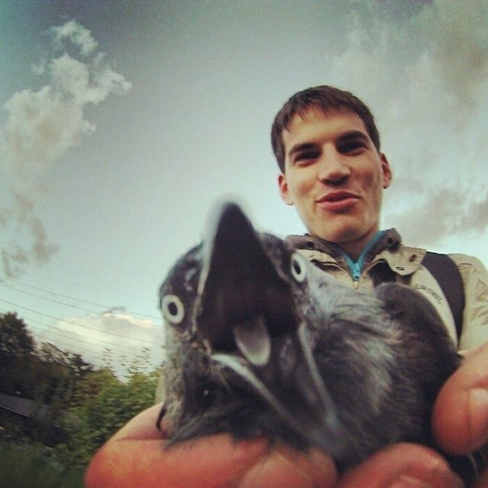 Person holding a crow