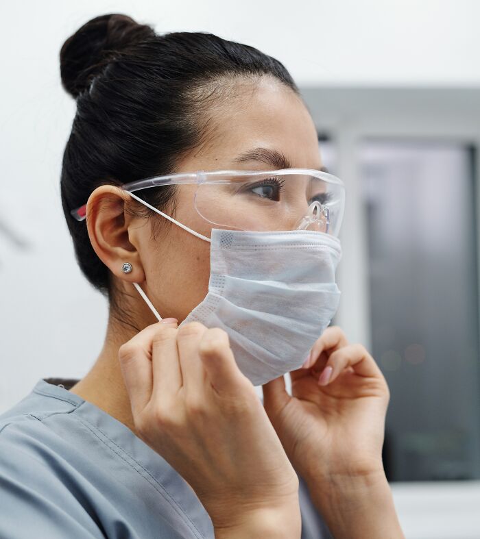 Woman With Face Mask And Glasses