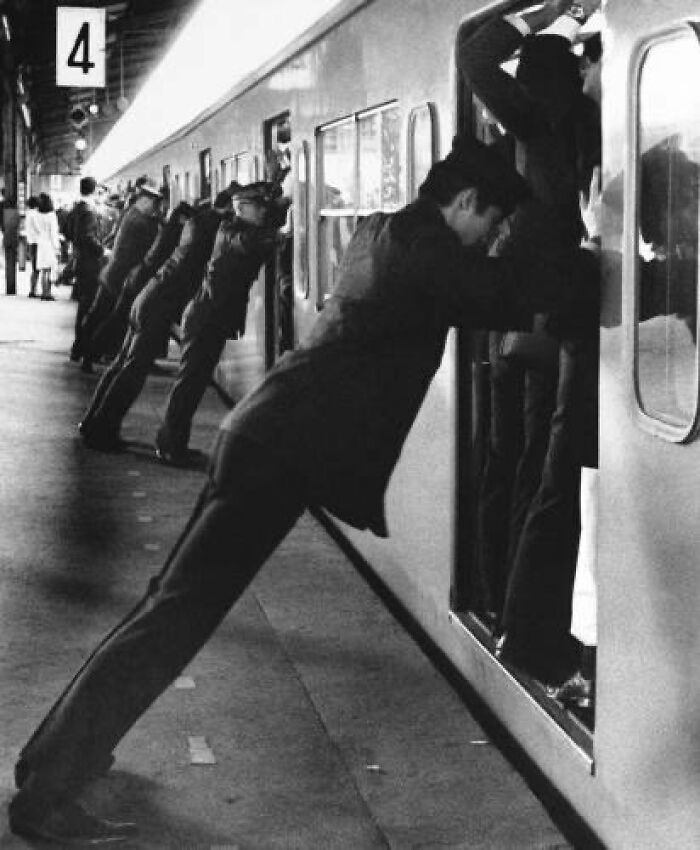 Tokyo Subway Pushers 1968: Stationmasters And Station Staff Push Passengers Into Train During Rush Hour At Shinjiku Station In Tokyo