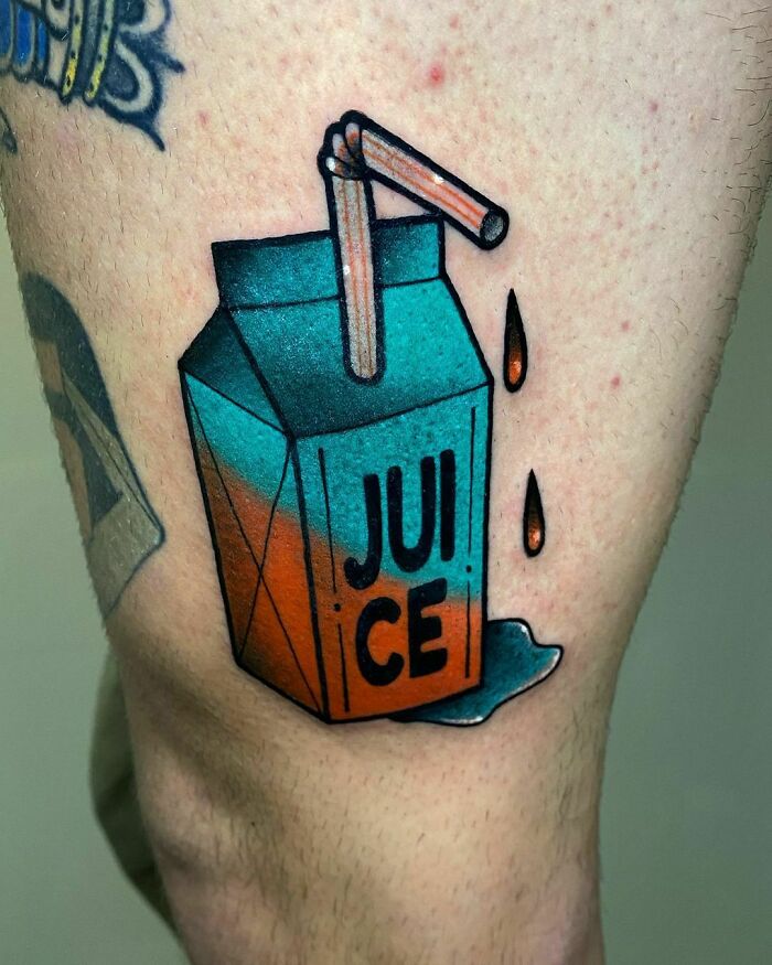 Watercolor juice box tattoo with vibrant colors on skin, featuring food-inspired ink-spiration.