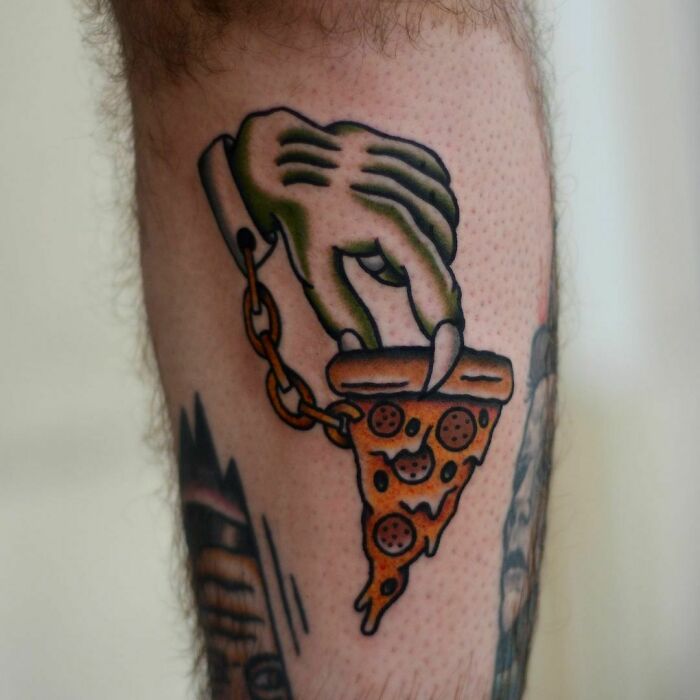 Zombie hand holding pizza slice tattoo, a creative food ink-spiration.