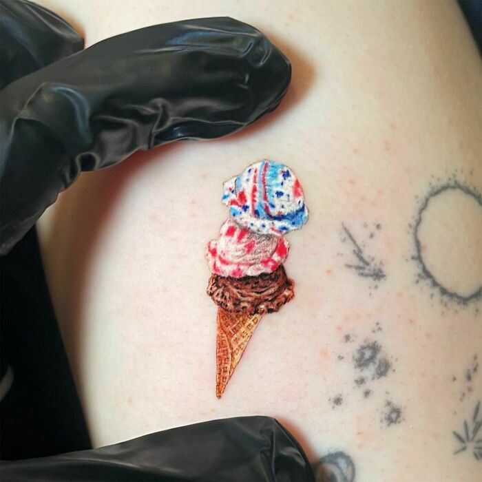 Watercolor ice cream tattoo on skin, a delightful idea for food-inspired ink.