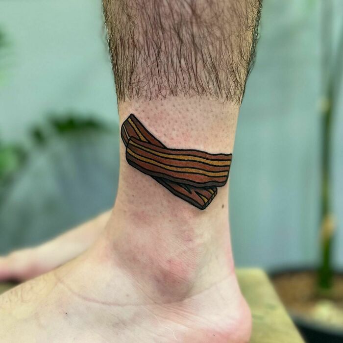 Bacon watercolor ankle tattoo showcasing food ink-spiration with vivid colors.