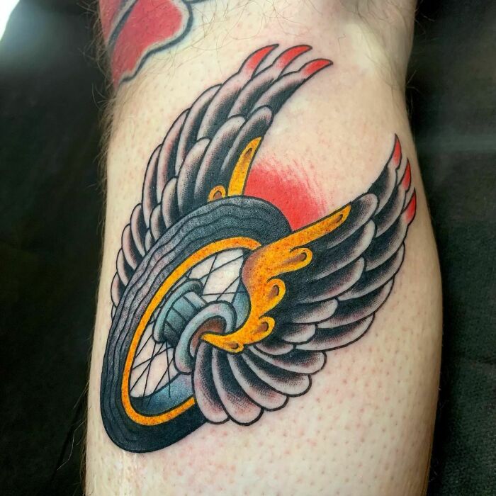 American traditional tattoo of a winged wheel with flames.