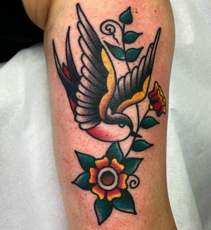 American traditional bird arm tattoo