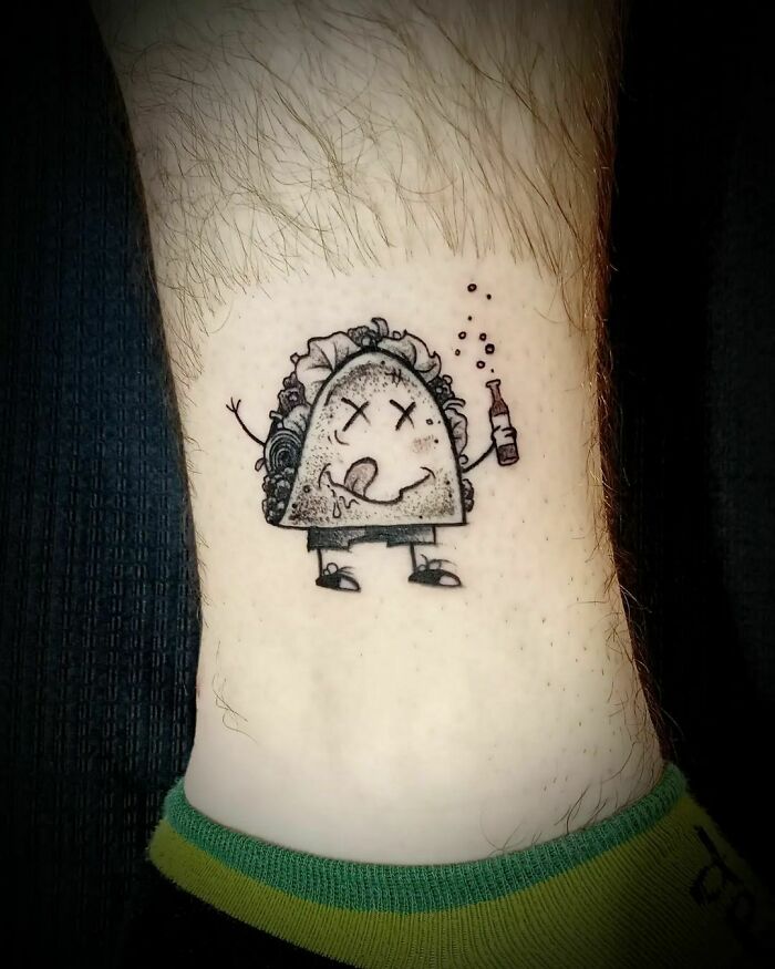Minimalistic tattoo of a cartoon drunk taco holding a bottle, showcasing a creative food-inspired design.