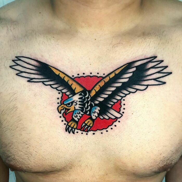 American traditional eagle tattoo on chest with vibrant colors and bold outlines for a timeless look.