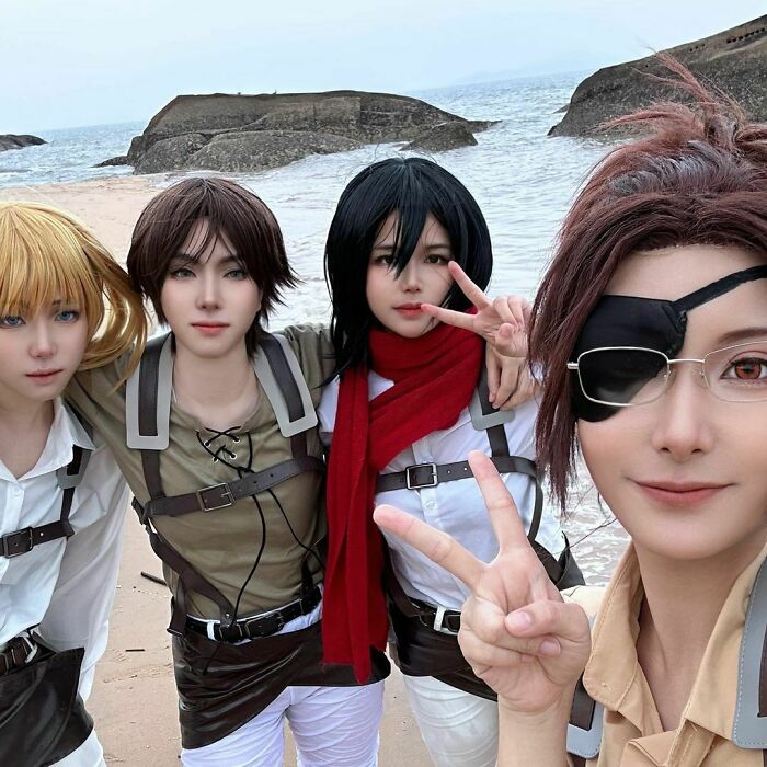 Persons cosplaying Armin, Eren, Mikasa and Hange from Attack on Titan